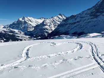 Scenic view of snow covered mountains against sky