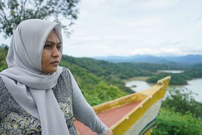 A woman sitting looking at nature