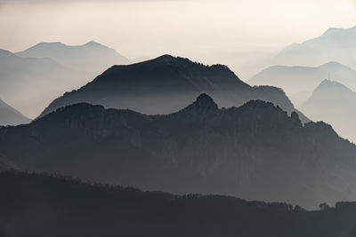 Scenic view of silhouette mountains against sky during sunset