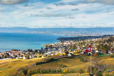 High angle view of townscape by sea against sky