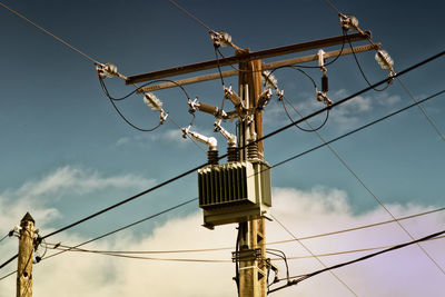 Low angle view of electricity pylon against sky