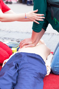 Midsection of women giving cpr on dummy