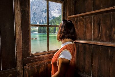 Woman looking through window