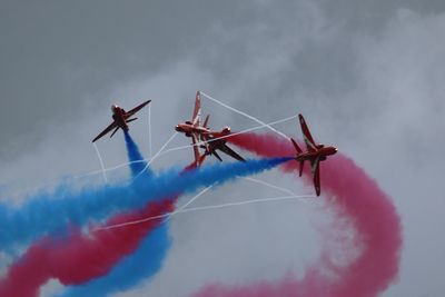 Low angle view of airplane flying against sky