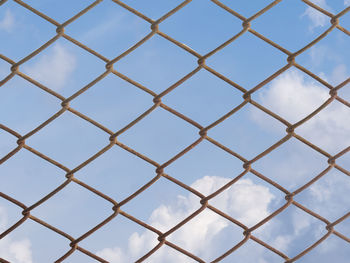 Full frame shot of metal fence against sky