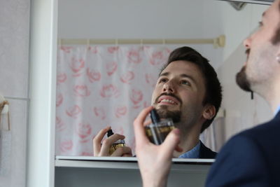Portrait of young man looking at camera at home