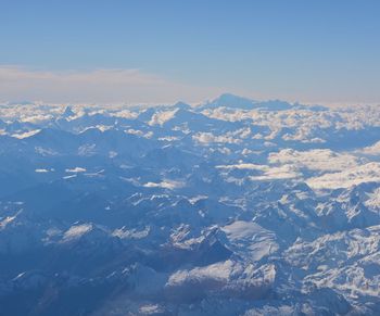 Aerial view of snowcapped mountains against sky