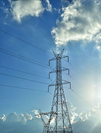 Low angle view of electricity pylon against sky