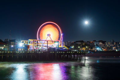 Santa monica pier at night with full moon