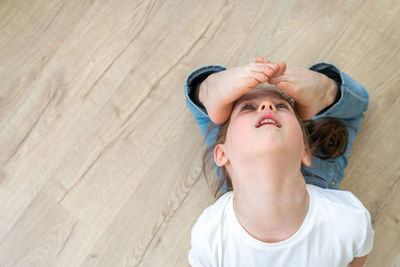 High angle portrait of woman lying on floor