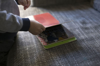 High angle view of boy with book at table