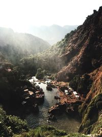 Scenic view of river and mountains against sky