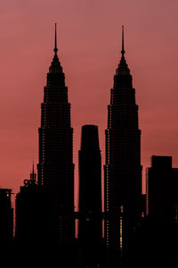 Low angle view of silhouette buildings against sky during sunset