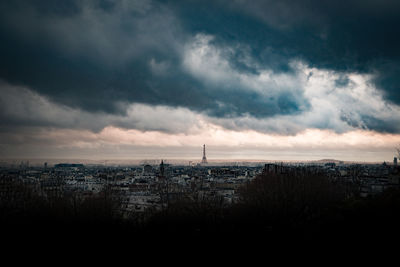 High angle view of buildings against cloudy sky