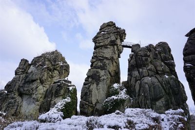 Low angle view of rock formations against sky