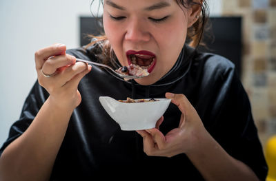 Midsection of woman eating ice cream