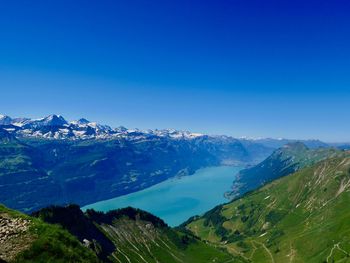 Scenic view of mountains against clear blue sky