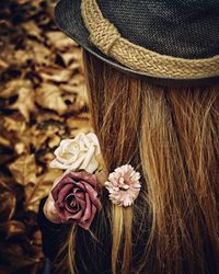 High angle view of women holding roses over shoulder