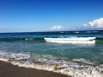Scenic view of sea against blue sky