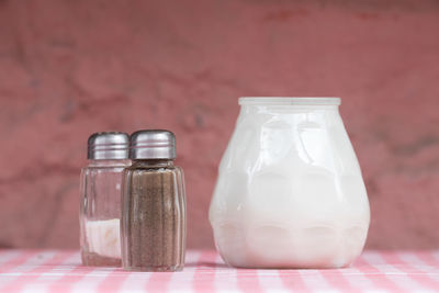Salt shakers and container on table at restaurant