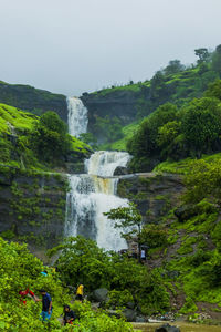 Scenic view of waterfall against sky