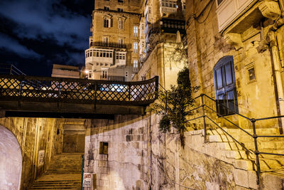 Low angle view of illuminated building against sky at night