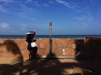 Silhouette of woman standing on beach