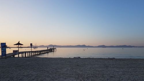 Scenic view of sea against clear sky during sunset