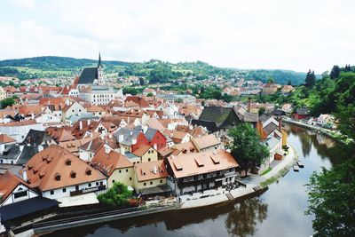 High angle view of townscape by river against sky