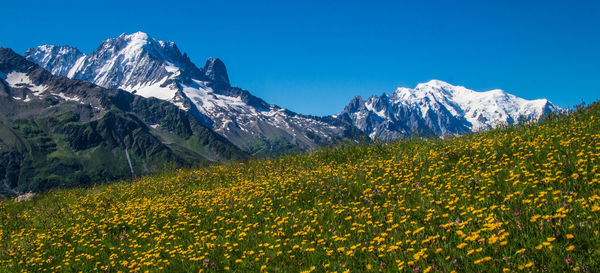 Scenic view of mountains against clear blue sky