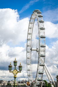 Low angle view of ferris wheel against sky