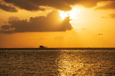 Scenic view of sea against orange sky