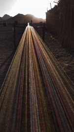 Surface level of railroad tracks on road against sky