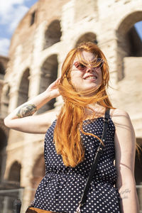 Delighted tourist outside ancient monument