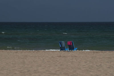 Lifeguard hut on beach against clear sky