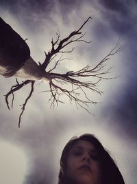 Low angle view of bare trees against sky