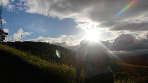 Scenic view of grassy field against sky