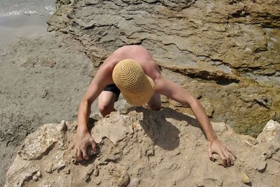 High angle view of woman on rock at beach