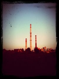 Built structures against sky at sunset