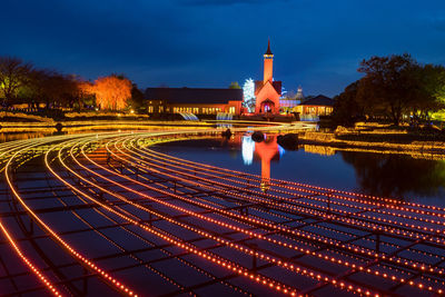 Aerial view of illuminated light trails against sky at night