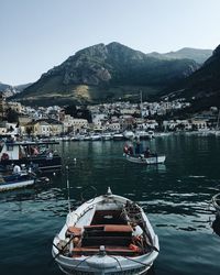 Boats in lake with town in background