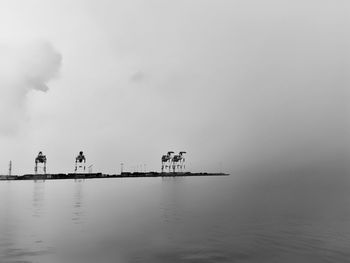 Earth and sky as one with silhouette of shipping port