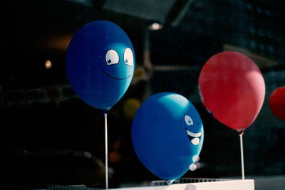 Close-up of multi colored balloons with smiley face