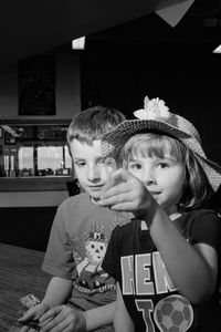 Portrait of cute siblings sitting outdoors