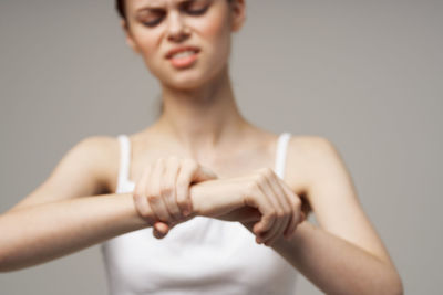 Portrait of woman standing against gray background