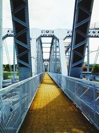 Suspension bridge against sky in city