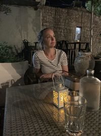 Portrait of woman sitting at restaurant table
