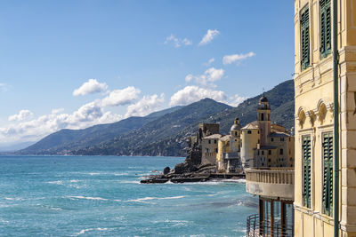 Scenic view of sea and mountains against sky