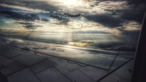 Close-up of airplane window against sky