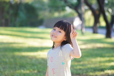Cute girl standing on field